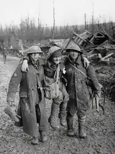 Bringing in an injured man Two soldiers help their wounded comrade, during World War I, photo by National Library of Scotland on Unsplash